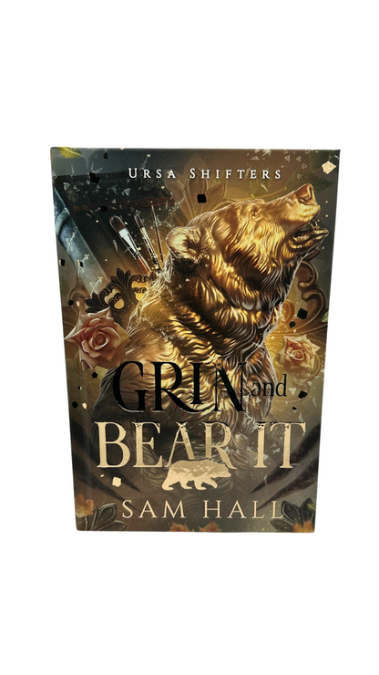 Book cover for Grin and Bear it by Sam Hall featuring a bear in gold foil