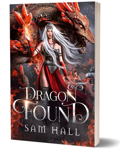 Book cover of 'Dragon Found' featuring a woman with white hair and red outfit standing next to a dragon.